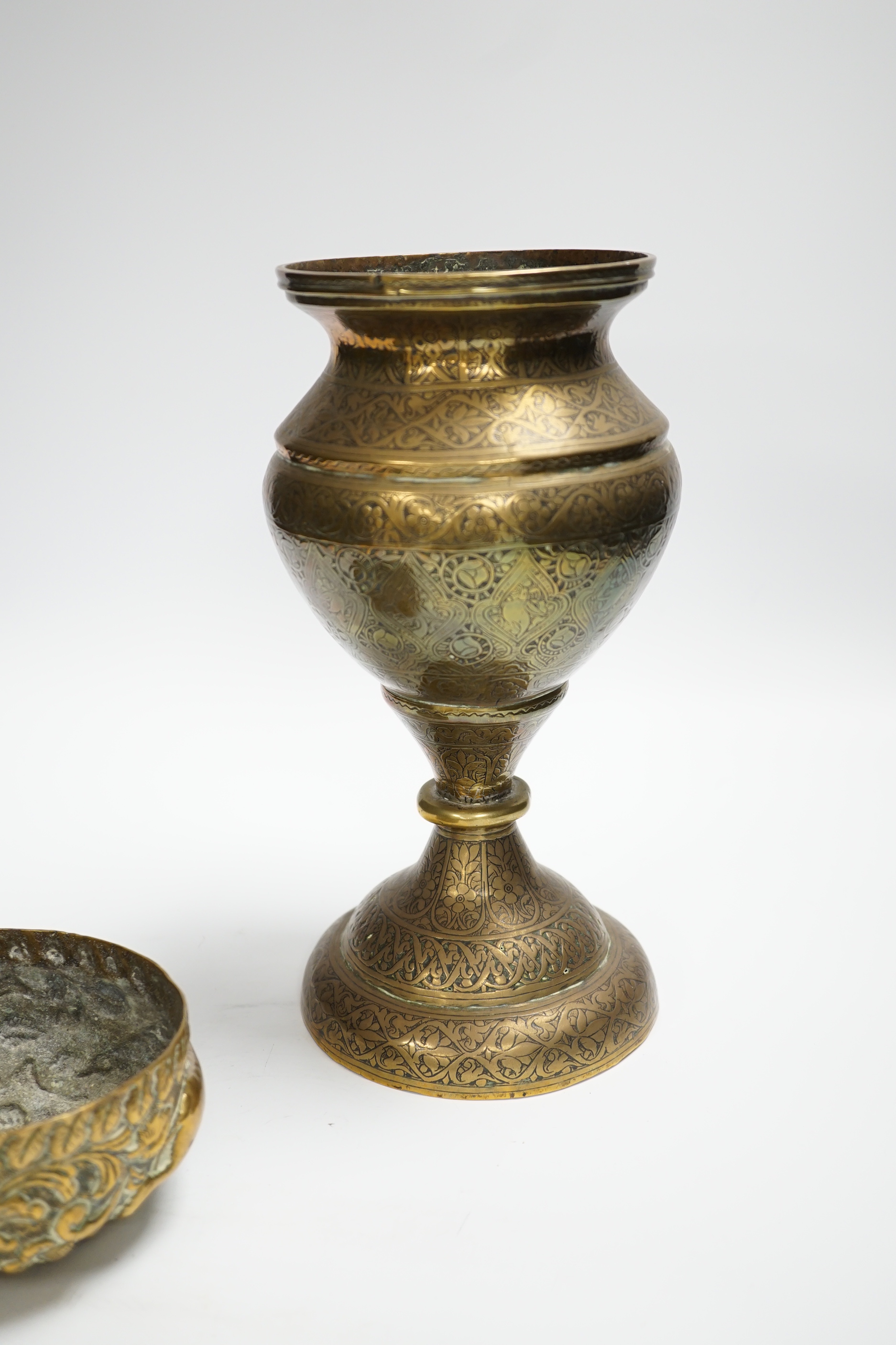 A Persian Qajar engraved brass vase and an Indian repousse brass bowl, largest 25cm high